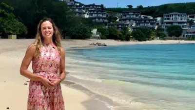 Nadia Dyson, owner of estate agency Luxury Locations, smiles for camera as she stand for beach in Antigua