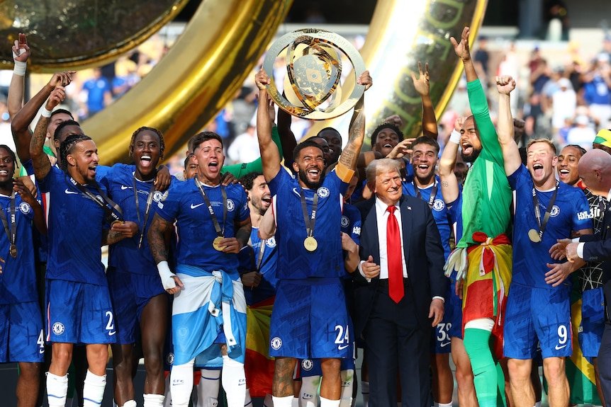 Reece James lifting the golden FIFA Club World Cup trophy next to Chelsea players and Donald Trump