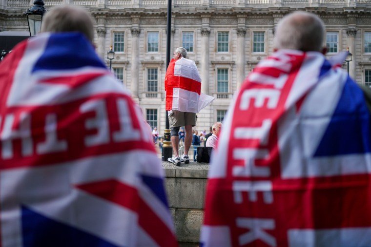 Protesters drape themselves in flags.